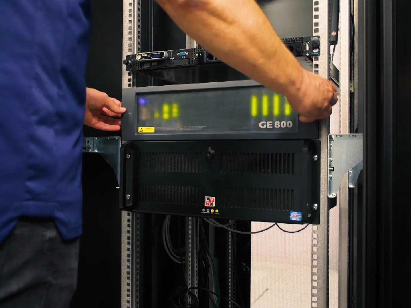 Engineer working on GE 800 rack server module used in PA and intercom communication control Technician installing GE 800 rack unit for PA and communication systems