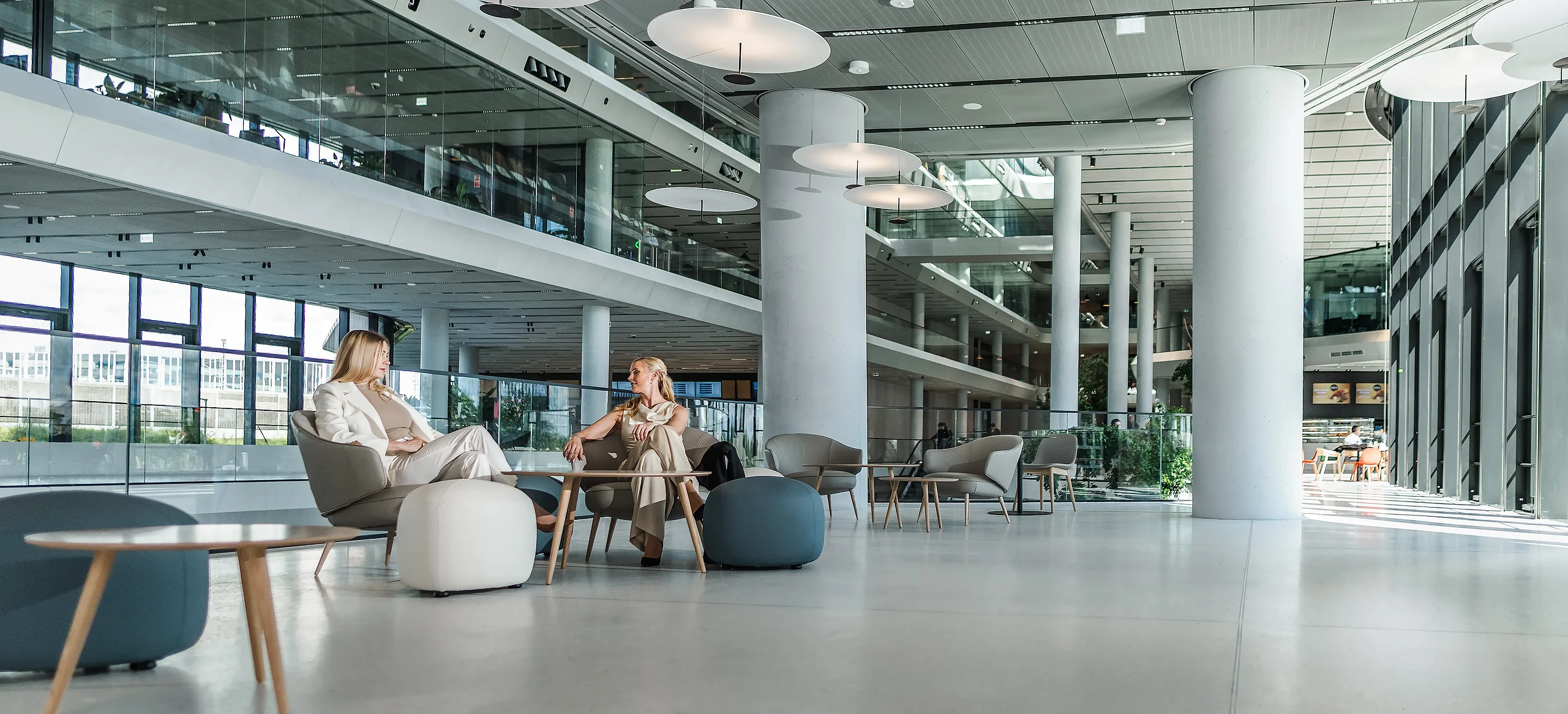 Bright modern lounge and meeting area inside MOL Campus with seating and open office spaces
