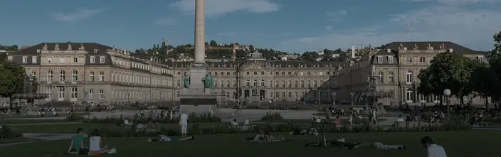 Stuttgart's Schlossplatz: Sunny Day Scene Panoramic view of Stuttgart's Schlossplatz with the New Palace, Königsbau, column, and people in the park.