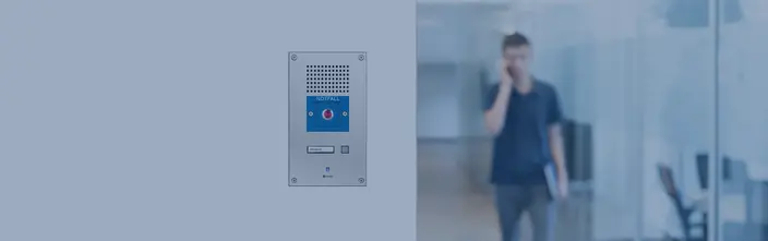 Reliable Office Intercom System Silver intercom panel with red emergency button ('NOTFALL') and 'Sekretariat' label in office, blurred person in background.