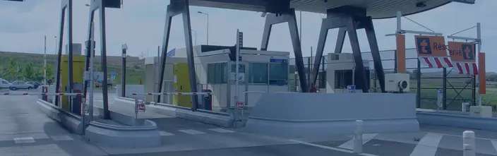 Toll Plaza Intercom System A highway toll plaza with several lanes, barriers, operator booths, and communication points.