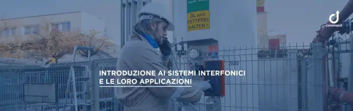 Worker using an industrial intercom system Worker on a site using an industrial intercom. German warning sign visible. Commend logo in top right.