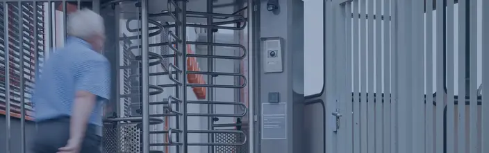 Intercom & Access Control Entry Person uses turnstile with intercom and access control at a facility entrance.