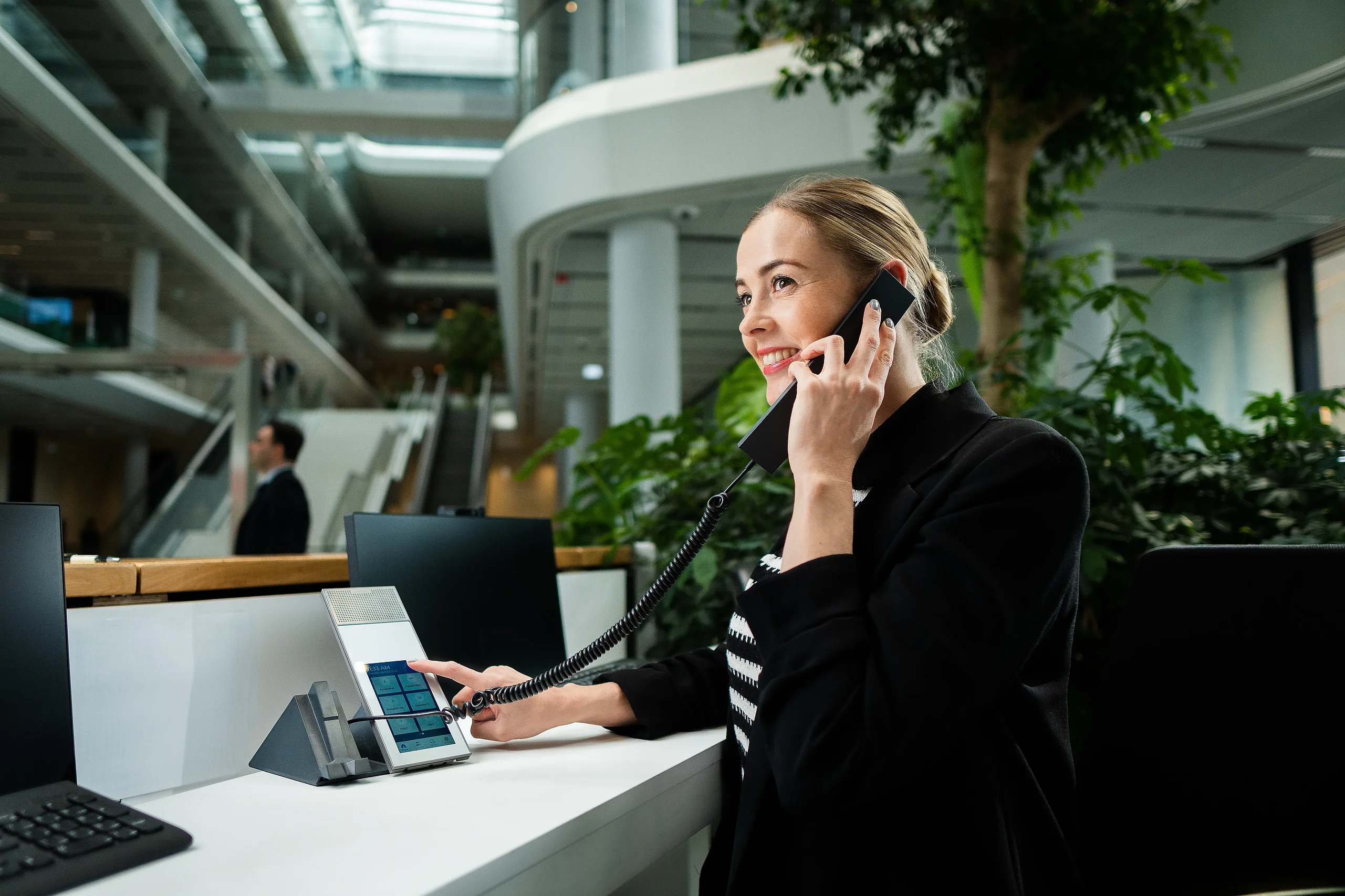 Receptionist using an Intercom communication terminal at the MOL Campus reception desk