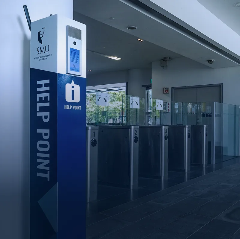 University help point next to electronic access gates providing secure entry and visitor assistance